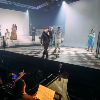 Stage Manager on stage speaking to conductor during a technical rehearsal